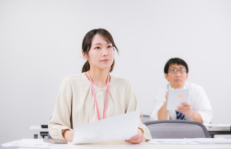 真剣な表情でミーティングに臨む女性社員の写真