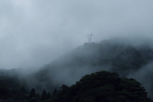 山を覆う濃霧と鉄塔（富山県南砺市）の写真