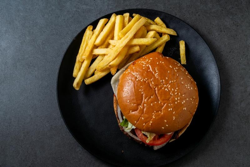 Hamburger and French Fries Set on a Black Plate