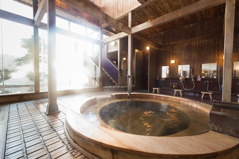 コウノマキを使用した珍しい源泉かけ流しの浴槽がある岡田旅館の内湯の写真