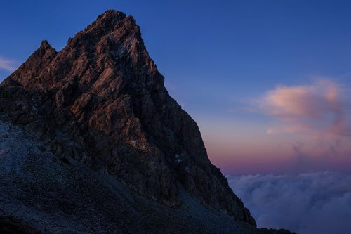 日没後の残光に淡く照らされた槍ヶ岳の写真