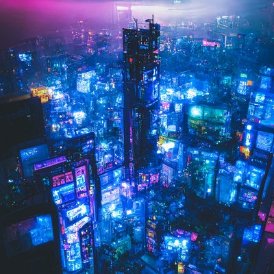 青い光に包まれる仮想空間の高層ビル群の写真