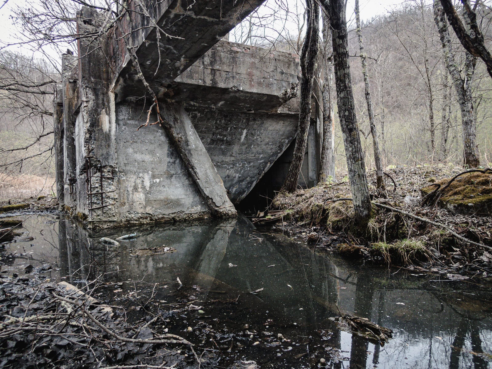 「汚れた水溜りと廃工場」の写真