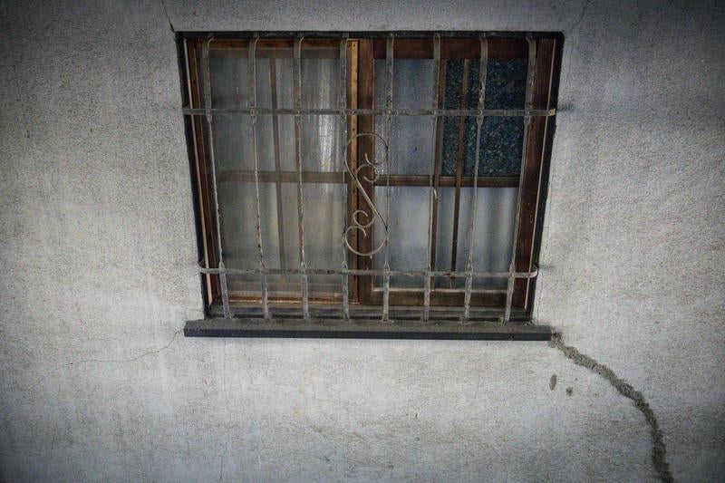 鉄格子のはまった古い小窓の写真