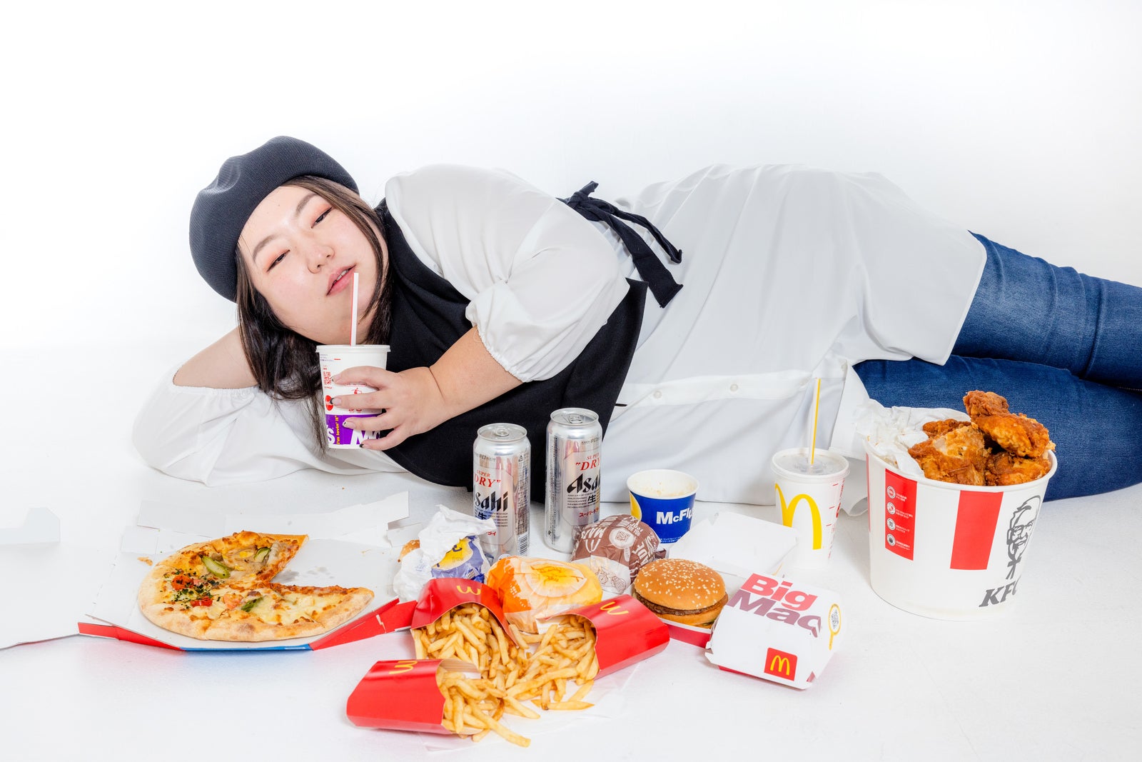 「「あーうめぇ」食後すぐに横たわる女性」の写真［モデル：KANA］