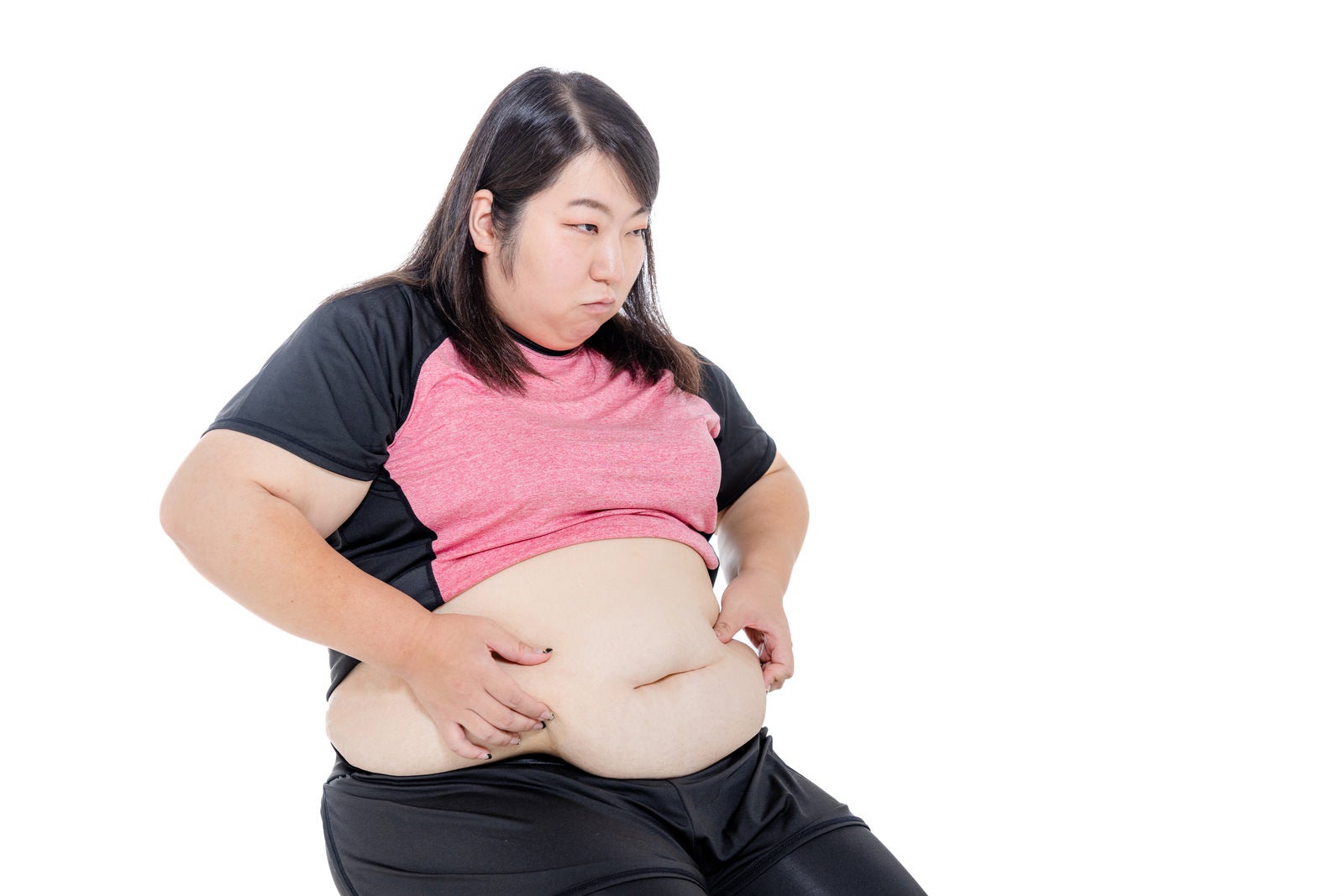 「皮下脂肪を気にする女性」の写真［モデル：KANA］