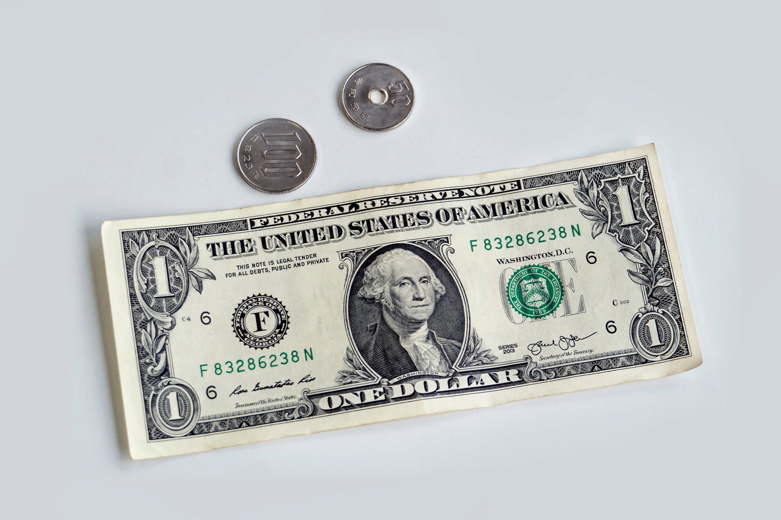 「150円玉と1ドル紙幣」の写真