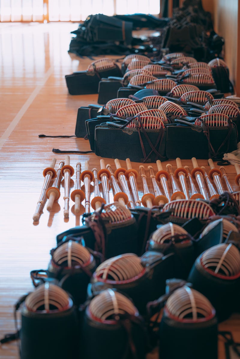 「ふたば未来学園の並べられた剣道の面と竹刀」の写真