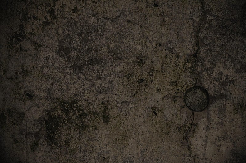 薄暗いコンクリート壁のテクスチャーの写真