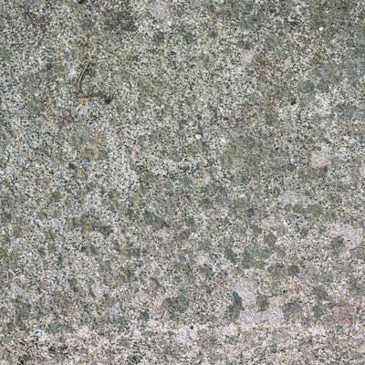 斑点模様に見えるコンクリートの地面の写真