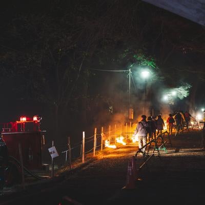 炎を持ち歩く松明あかしの参列者の写真