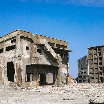 軍艦島の崩れ行く鉄筋の建物と瓦礫の写真