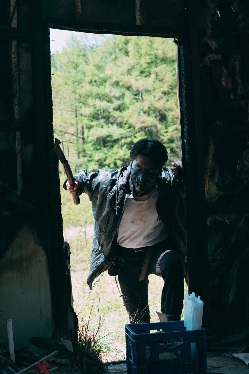 Suspicious Man Peering from the Window Frame of an Abandoned Building in Japan