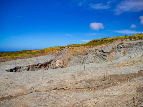 硫黄島西側の荒れ地にぽっかりと口を開けた鶯地獄（阿蘇台陥没孔）の写真