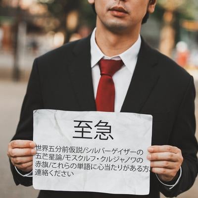 不穏な緊急警告文を持つ謎の人物の写真