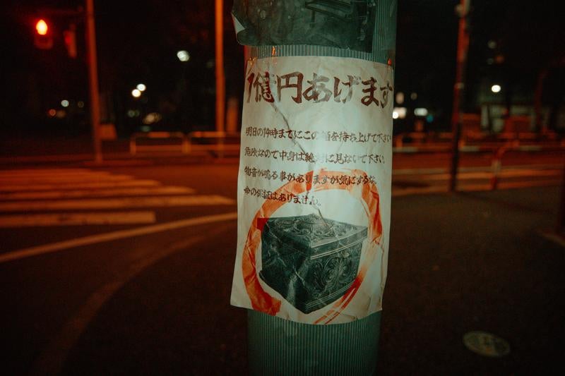 深夜の電柱に残る呪いの貼り紙の写真