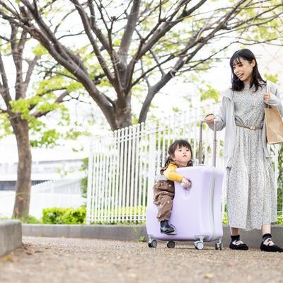 キャリーケースに乗って親子でおでかけの素材