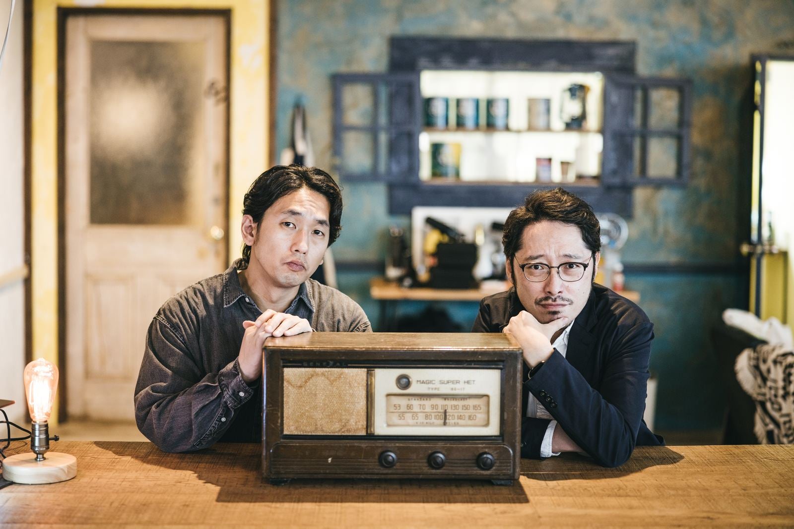 「ラジオと一緒に記念写真を撮る男性二人組」の写真［モデル：大川竜弥 ゆうせい］