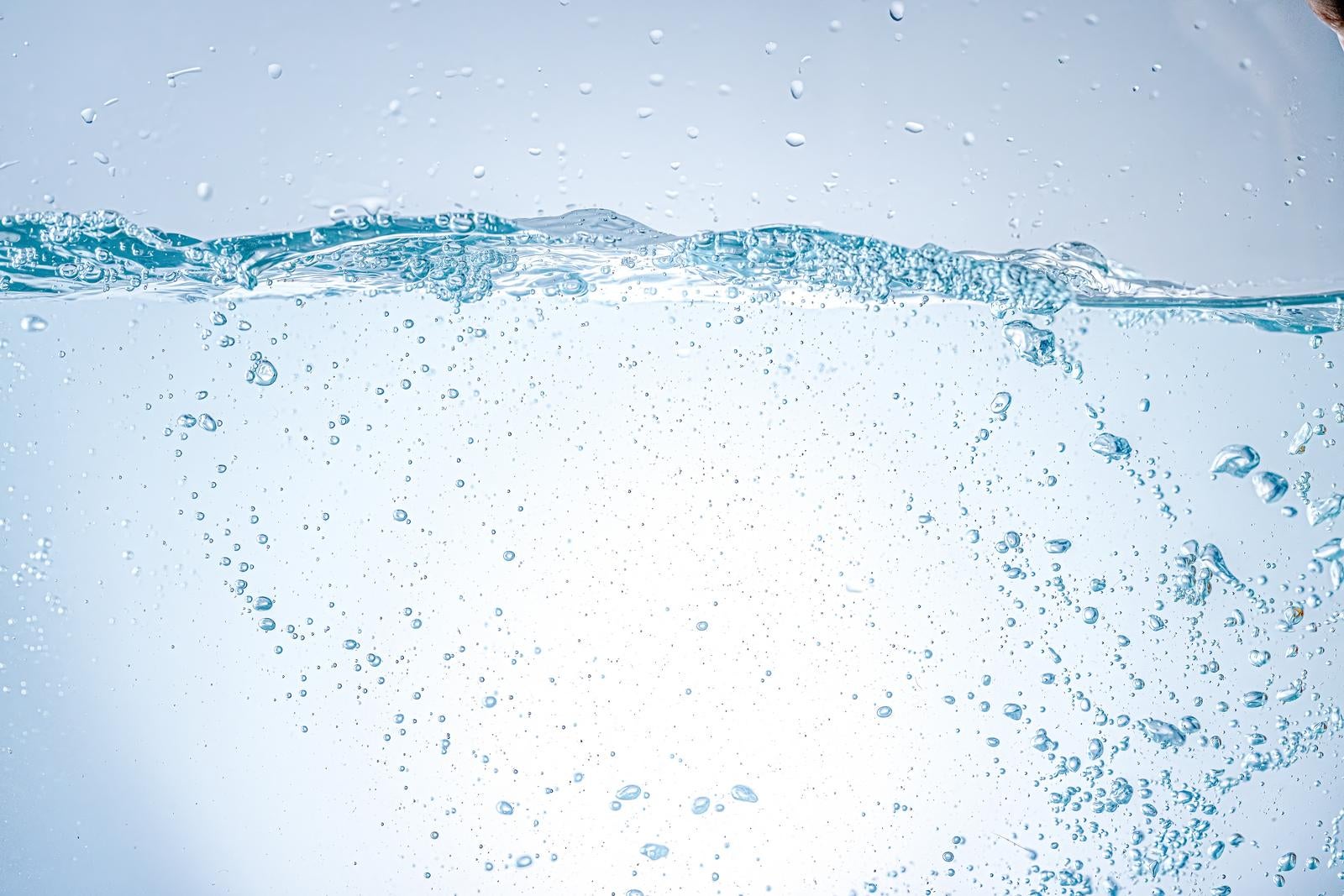 「細かい気泡が透明な水の中を漂う様子」の写真