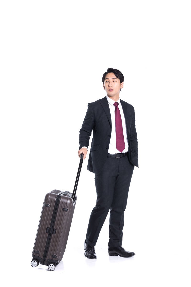 「出張帰りのビジネスマン」の写真［モデル：大川竜弥］