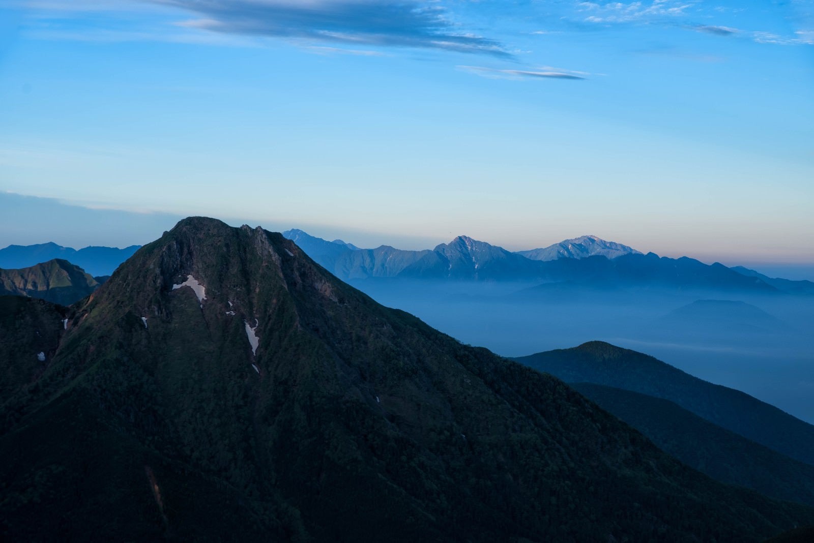 「阿弥陀岳と霞がかる南アルプス」の写真