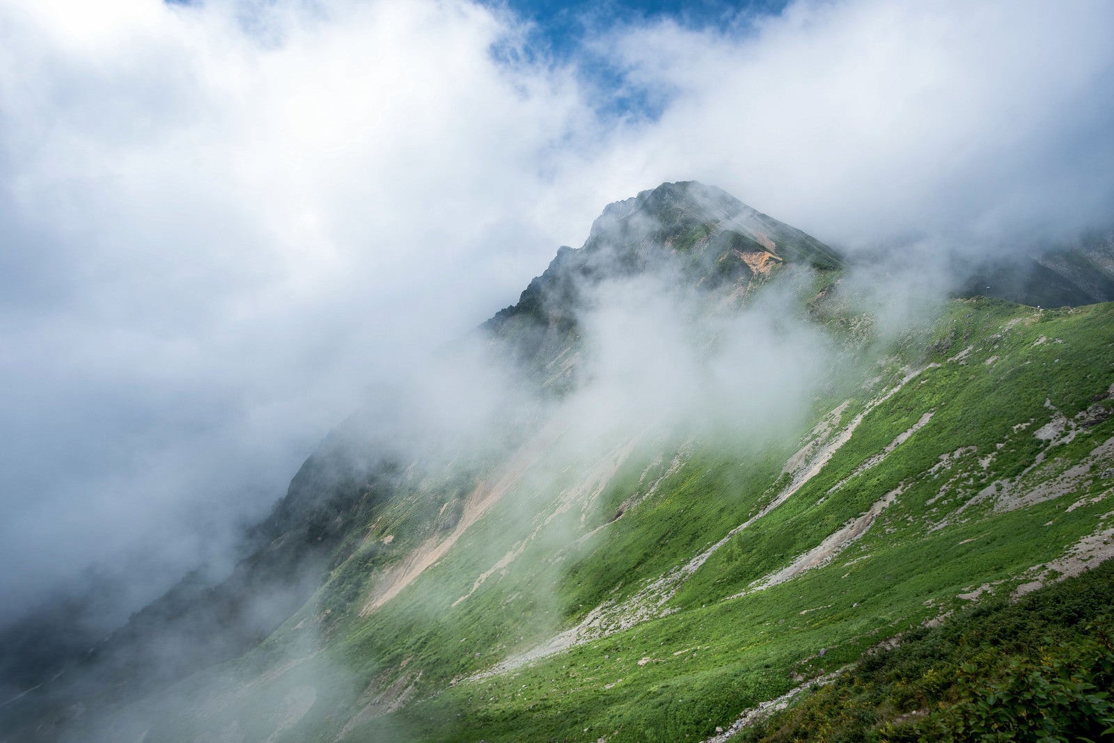 「山の傾斜にかかる雲」の写真