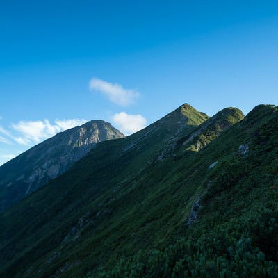 稜線から伸びる傾斜面と青空の写真