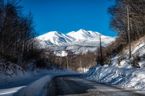 乗鞍岳へと続く残雪の道路の写真