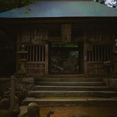 暗がりから浮かび上がる東堂山満福寺仁王門の写真