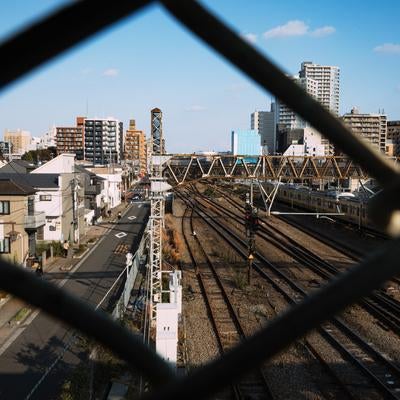 金網越しから見える三鷹電車庫跨線橋からの景観の写真