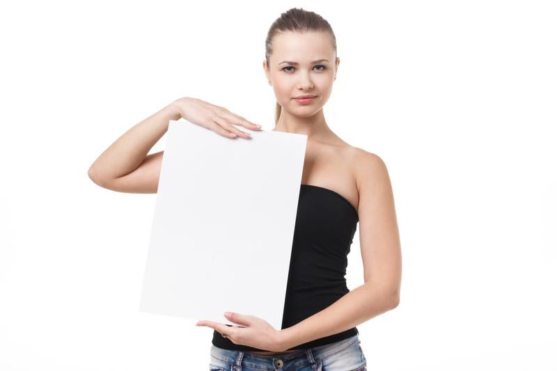 黒いベアトップを着て白いパネルを持つ女性の写真