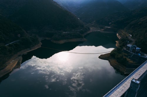 福智山ダム湖面に反射する空の写真