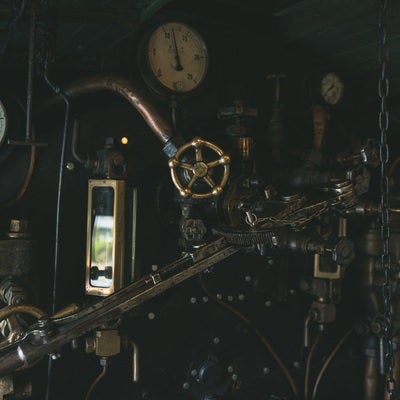 機関室内の圧力計とハンドルの写真