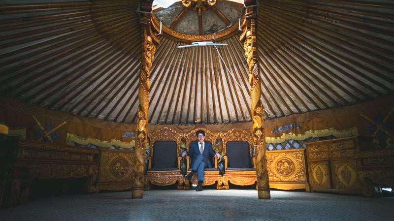 ゲルの中の王座に座るスーツ姿の男性の写真