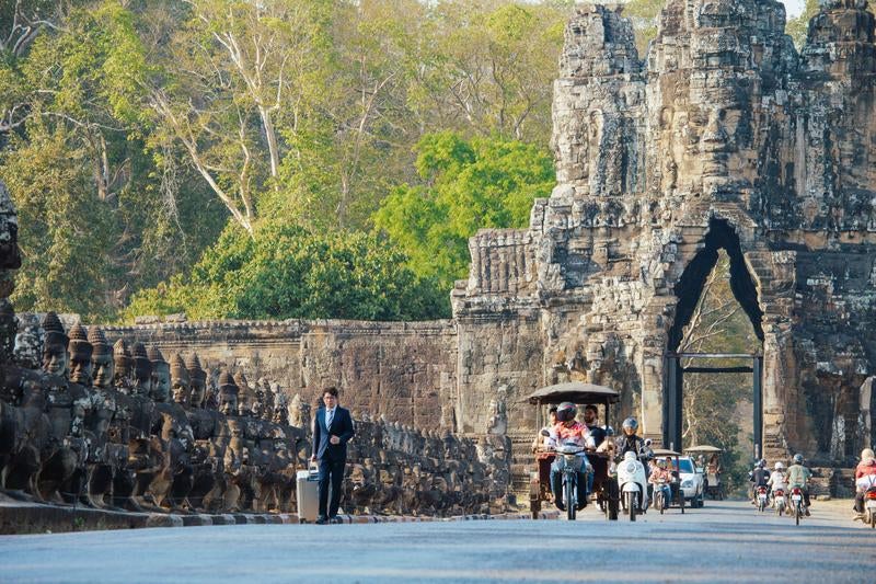 アンコール・トムの南大門前を歩くビジネスマンの写真
