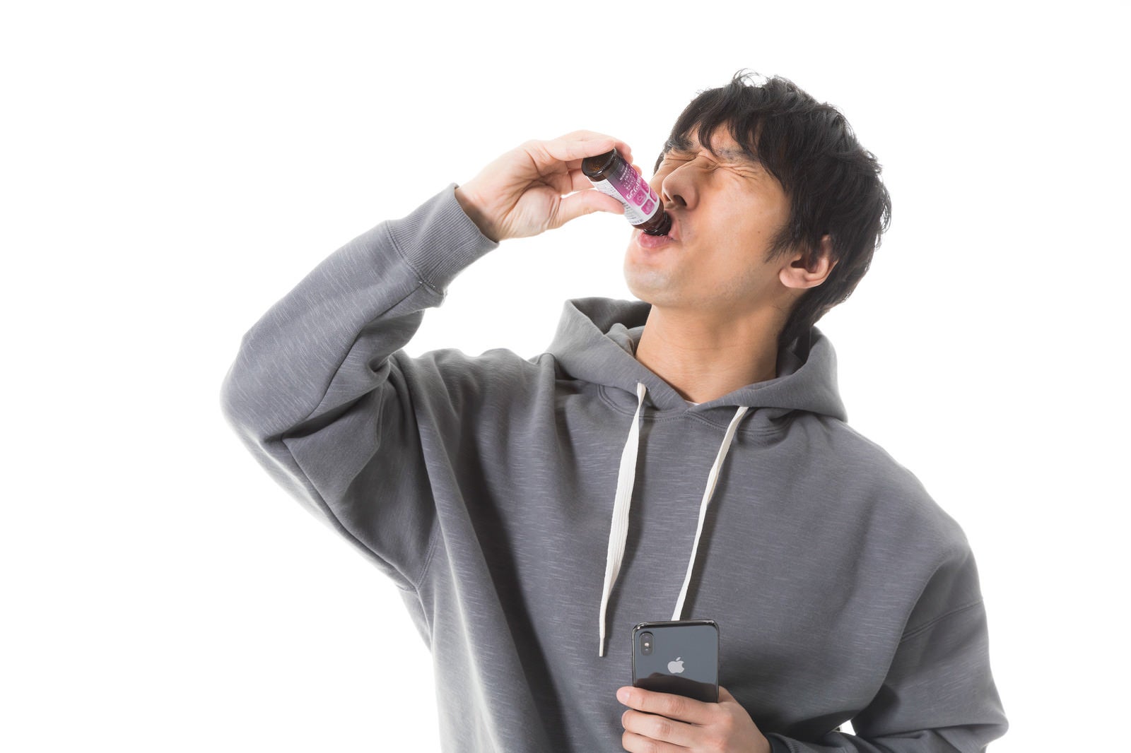「眼精疲労時に栄養ドリンクを飲むソーシャルゲーマー」の写真［モデル：大川竜弥］