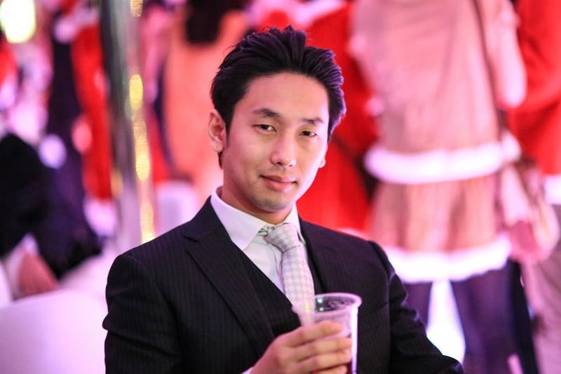 黒いスーツにグレーのネクタイを締めた男性が