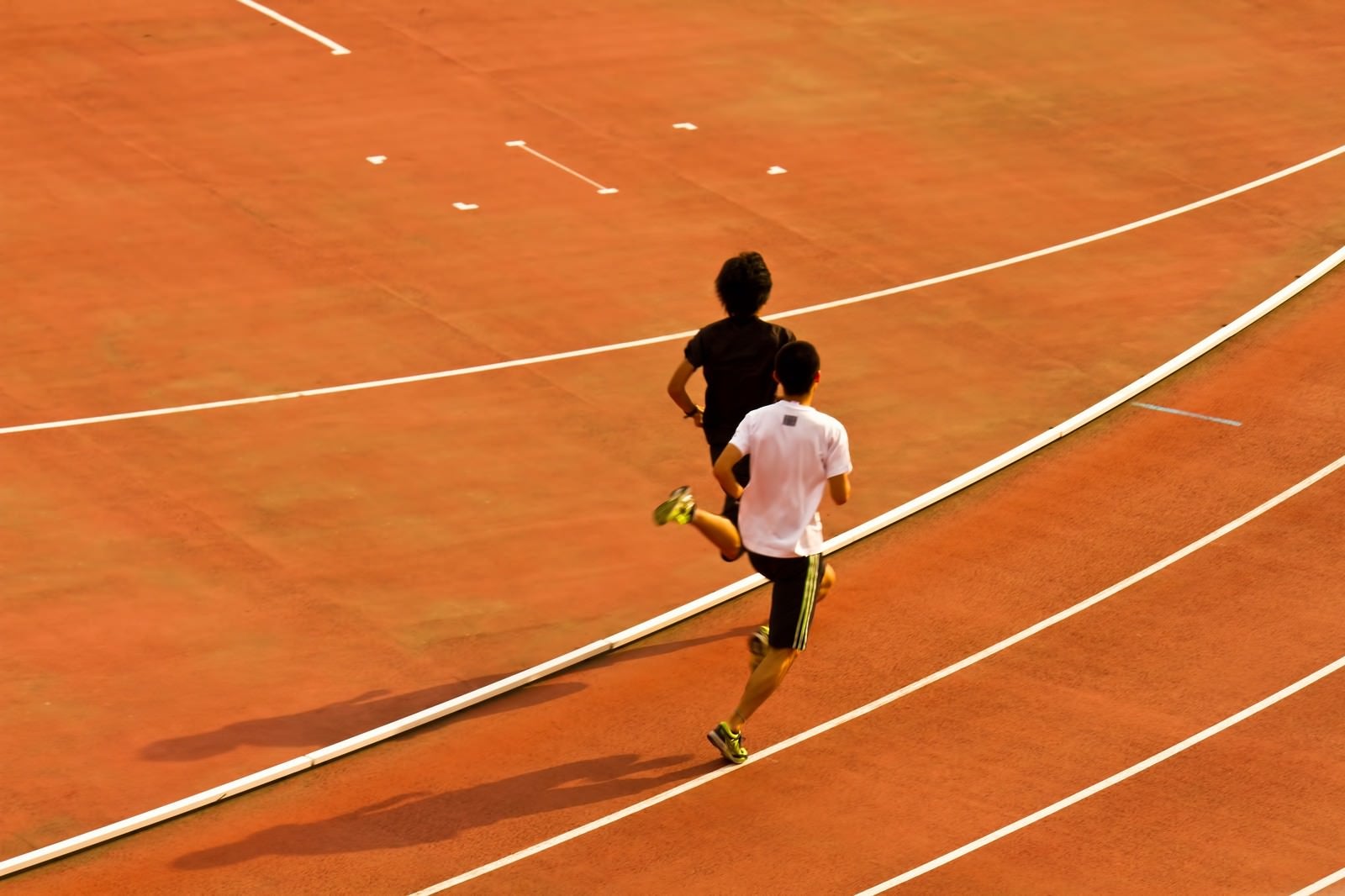 「競技場を走る陸上選手」の写真
