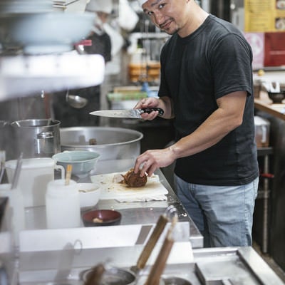 ラーメン屋の厨房を任せられた外国人店員の写真