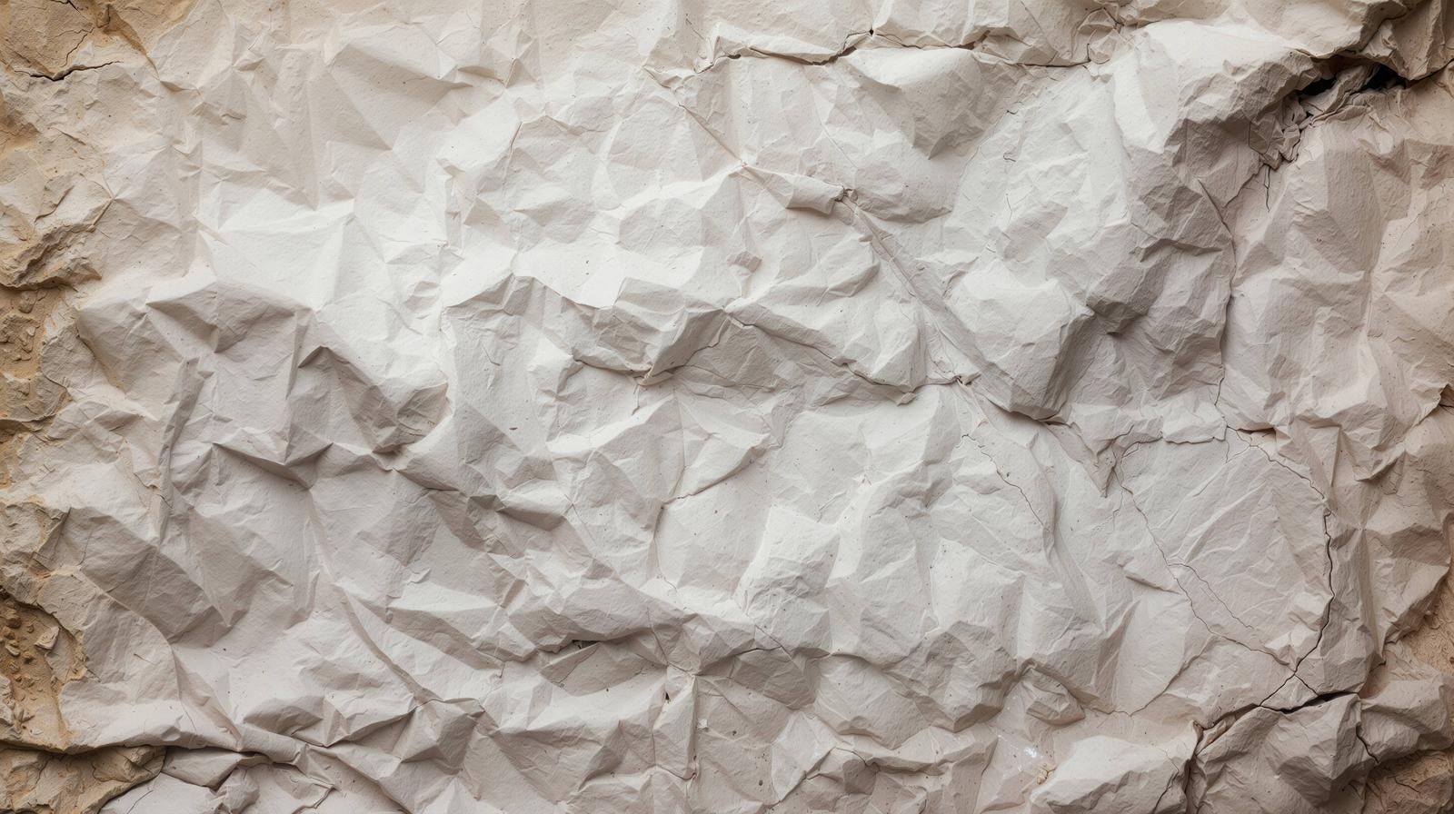 ベージュ色で細かなしわと凹凸が全面に広がるクラフト紙風のテクスチャー