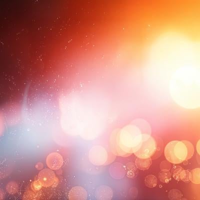 幻想的な光の玉が浮かぶ暖色系のぼかし背景の写真