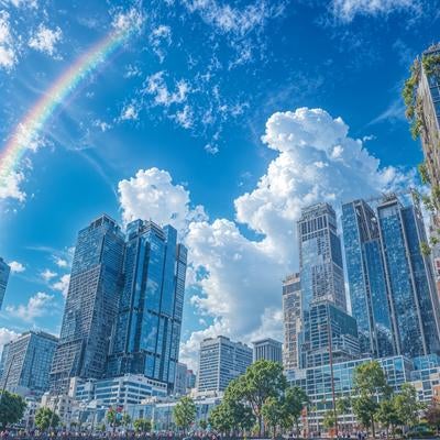 虹が架かる青空と高層ビル群の素材