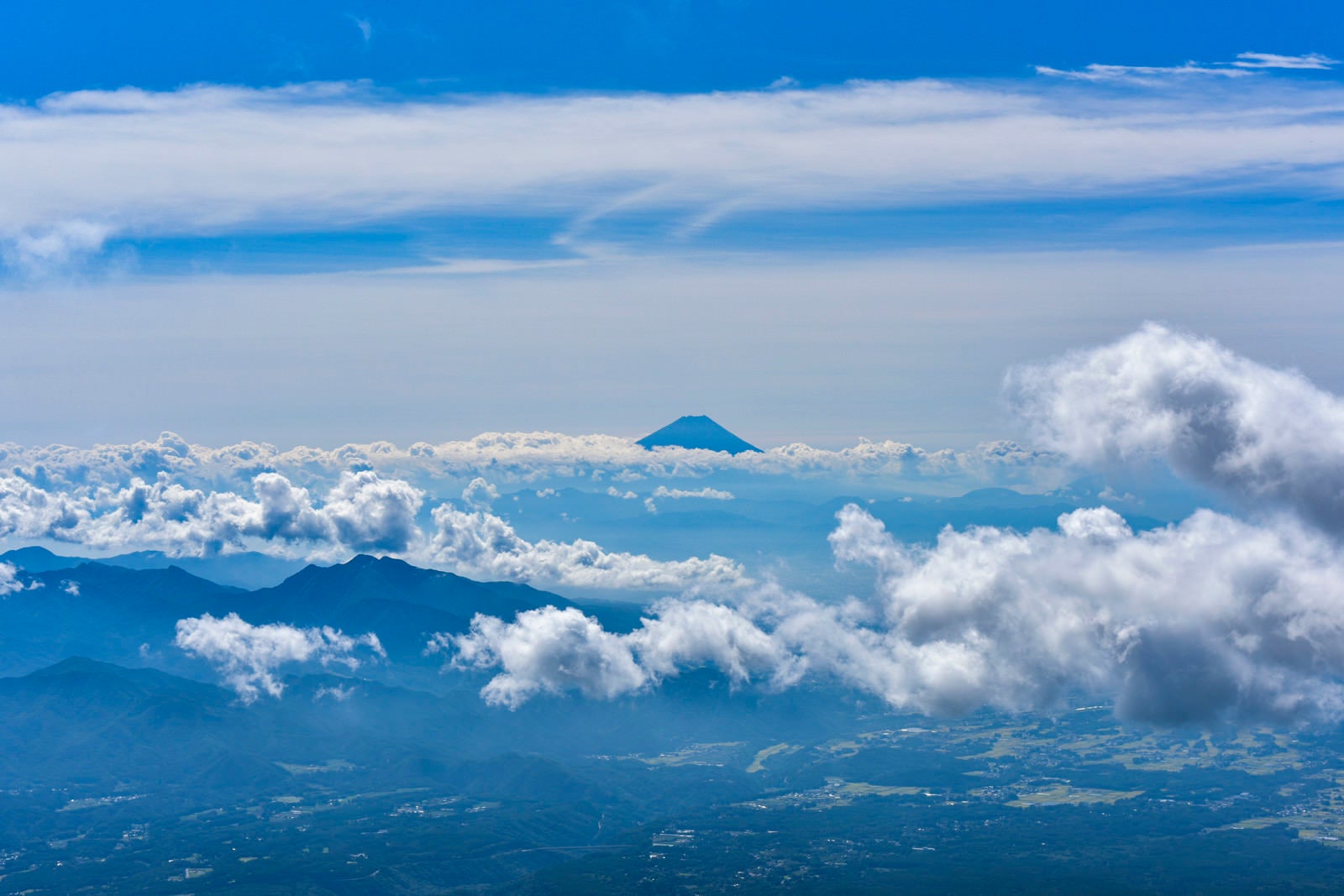 「八ヶ岳から見るとシルエットだけが見える富士山（赤岳）」の写真
