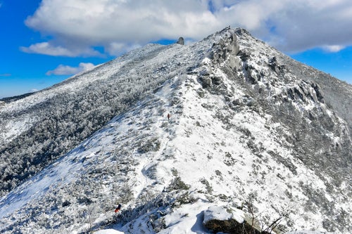 金峰山山頂の五丈岩を目指して歩く登山者の写真