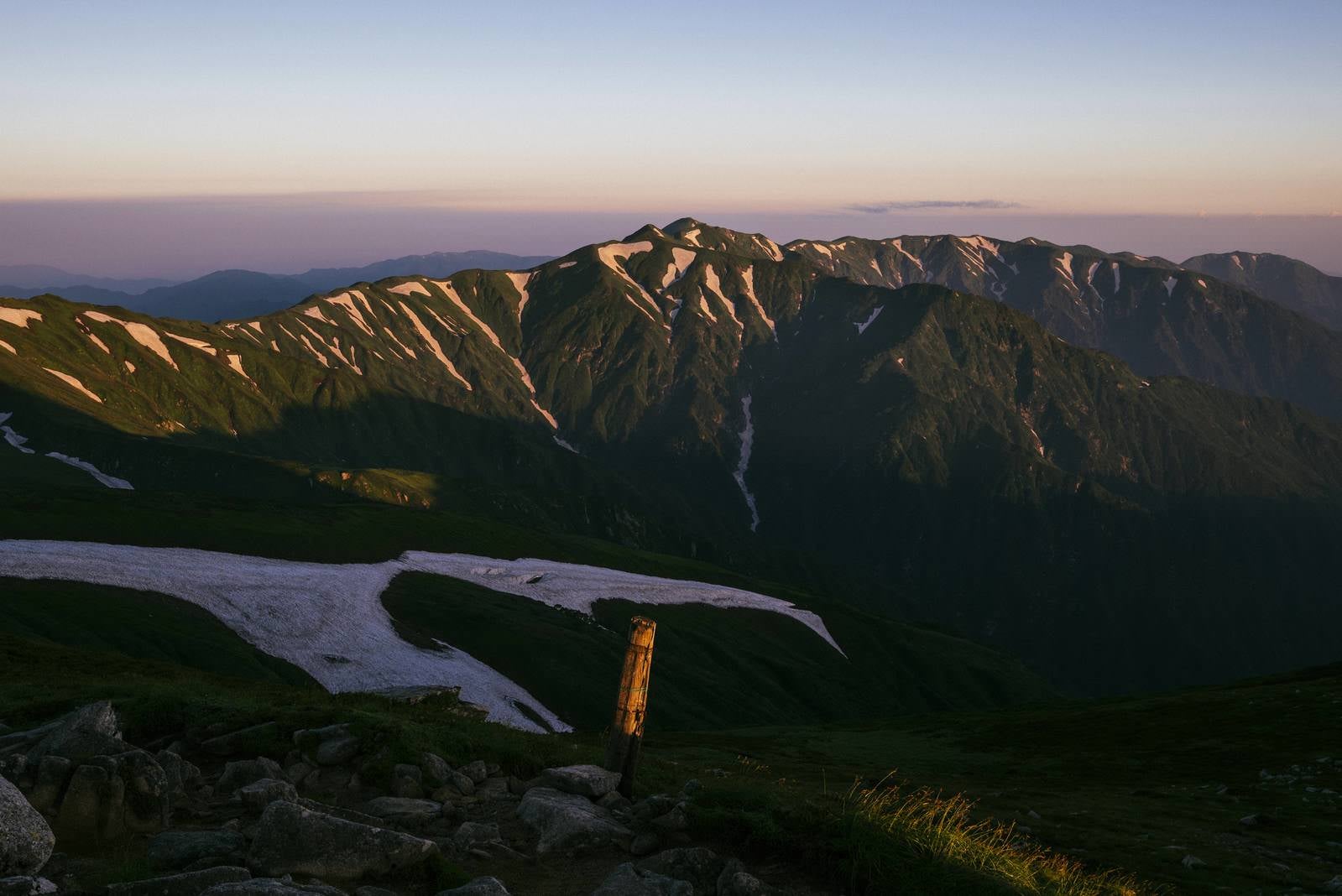 「夜明けの飯豊本山から北部の山々を見る」の写真