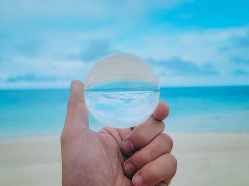 水晶玉から覗く南国の砂浜の写真