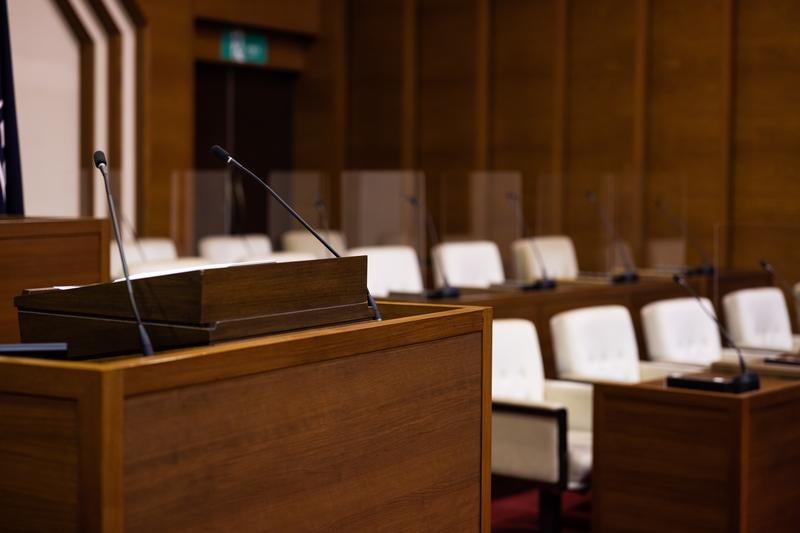 演壇を中心に白い椅子が整然と並んでいる議員席の写真