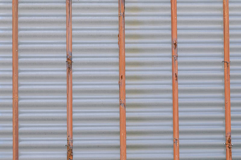 鉄棒で支えるフェンス裏側の写真
