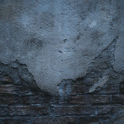 煉瓦の外壁を覆うコンクリート（テクスチャ）の写真