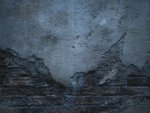 煉瓦の外壁を覆うコンクリート（テクスチャ）の写真